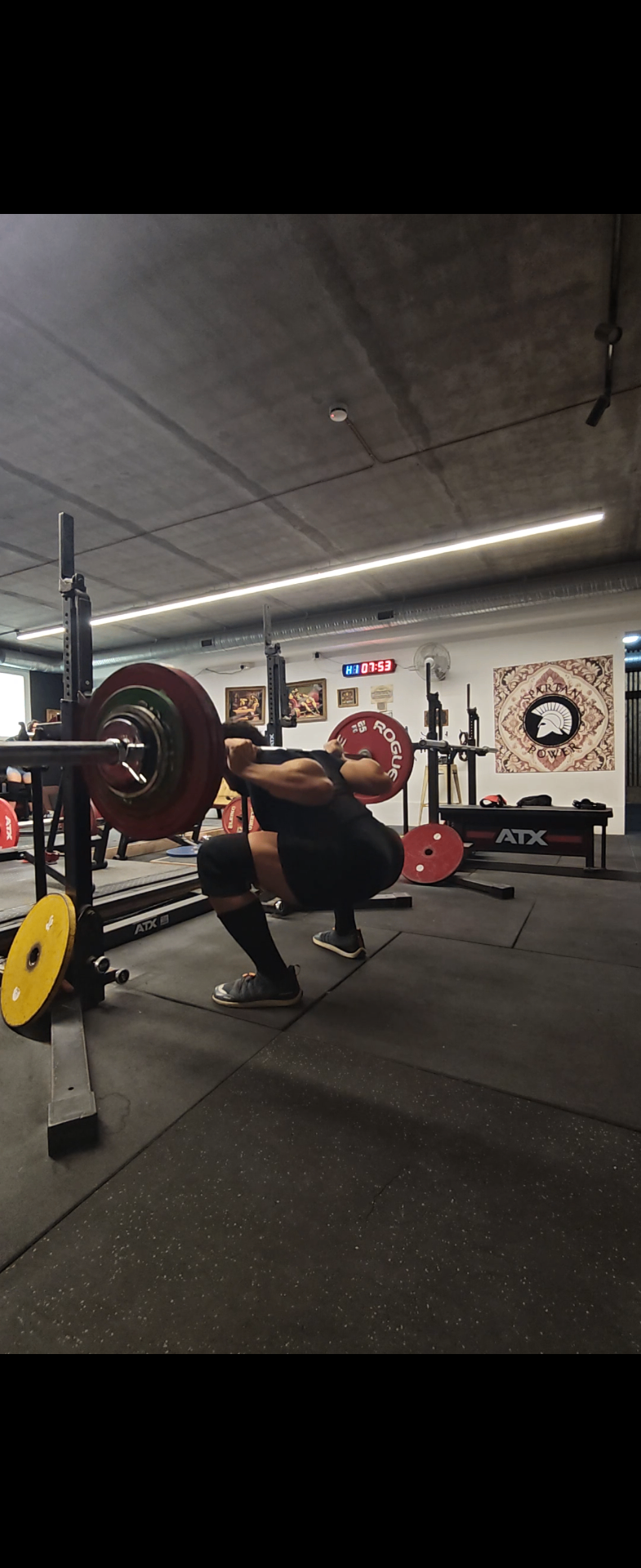 Chalked hands gripping a loaded barbell
