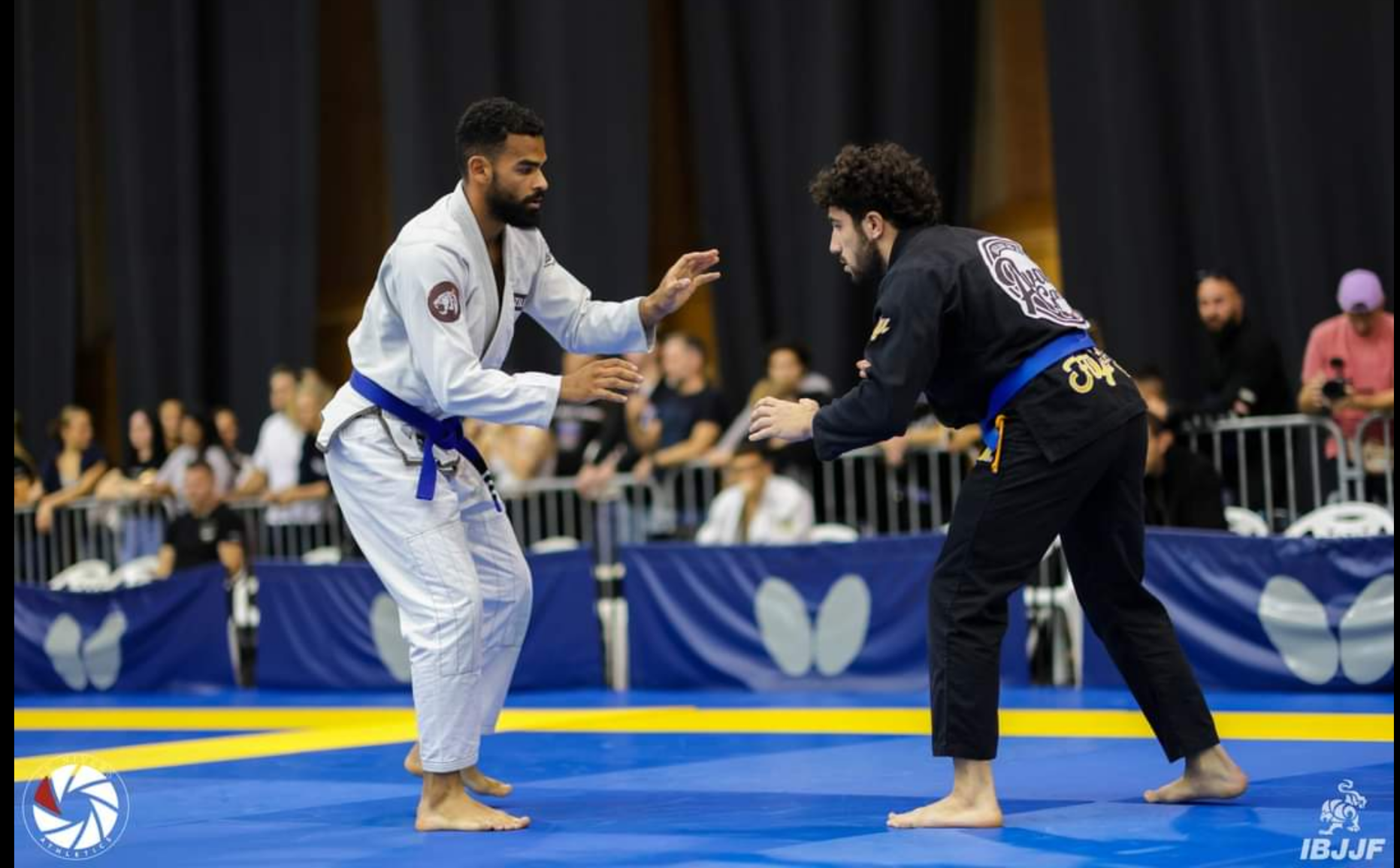 Top-down view of two BJJ practitioners gripping gi collars