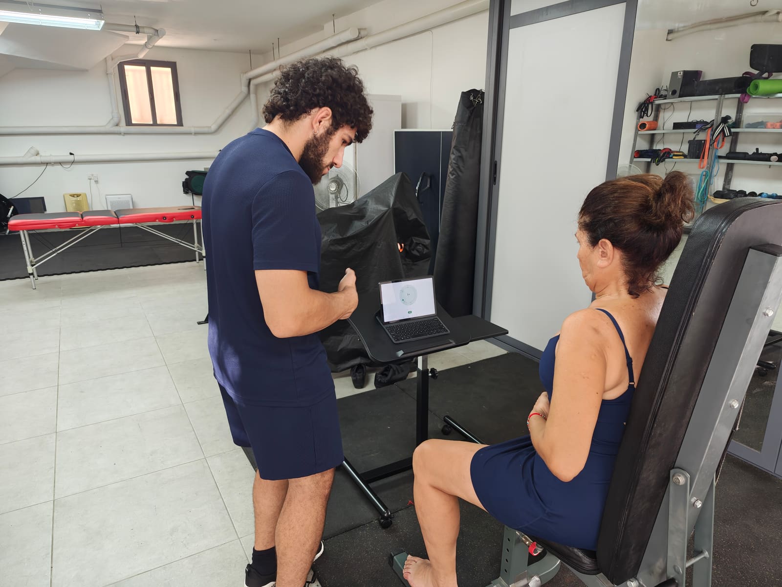 Coaching a leg extension while the Calmer tool runs on the laptop